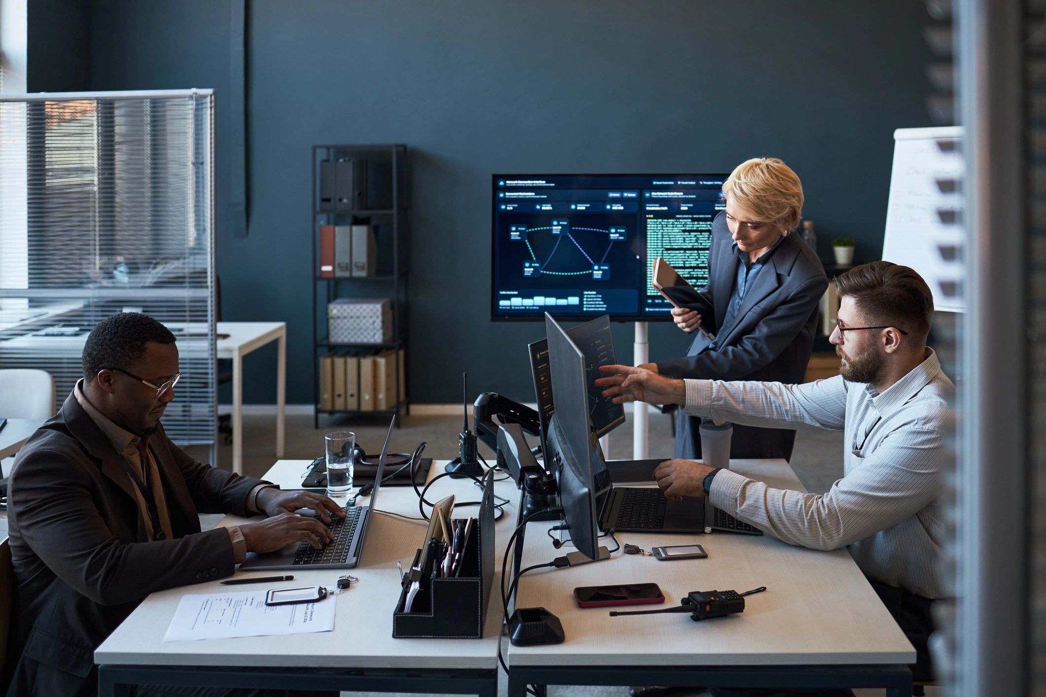 Technology professionals reviewing operational data in an office